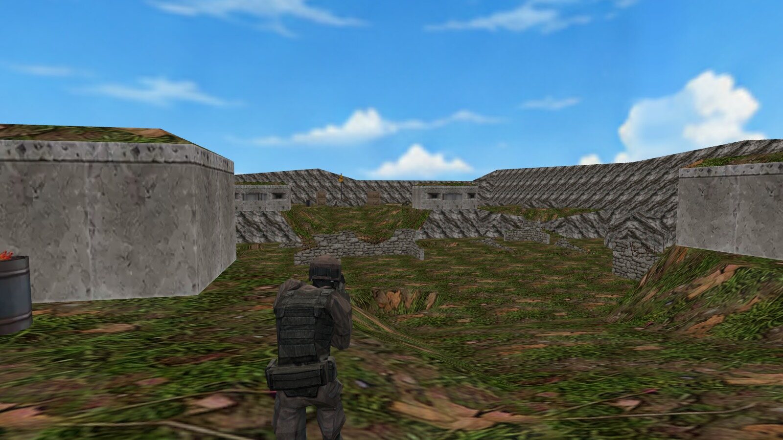 An operator holding behind a concrete wall overlooking the Bunkers field